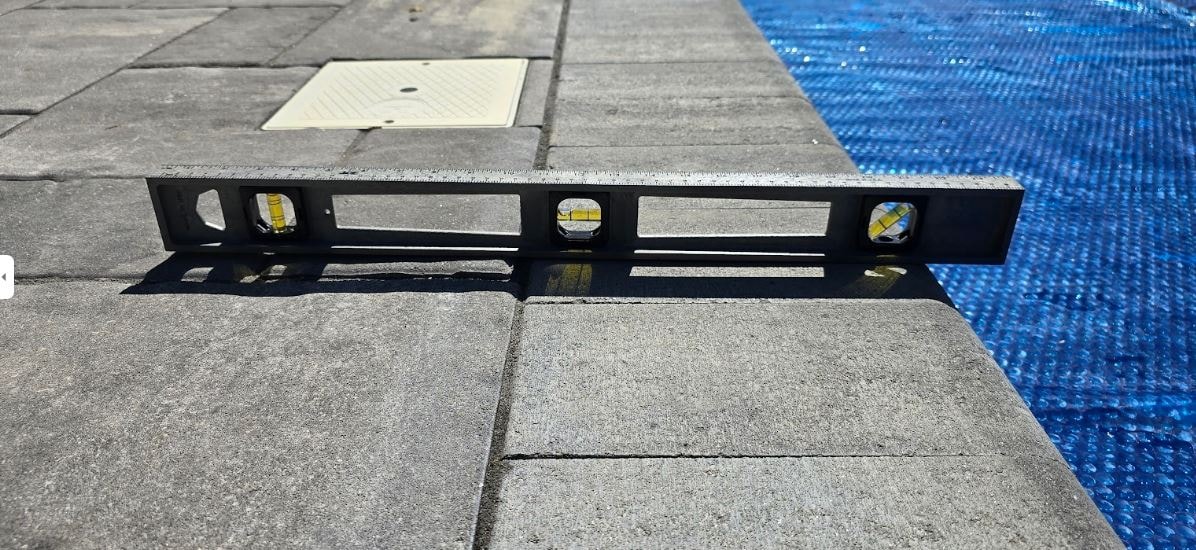Pavers all around the pool pitched to send rain water and run off into the pool